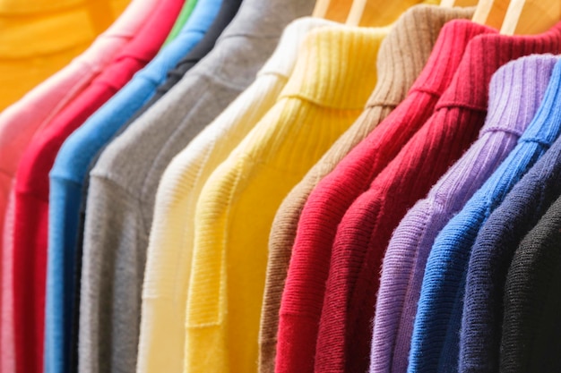 Ropa de moda en el estante de ropa armario colorido brillante primer plano del arco iris elección de color de la ropa femenina de moda en colgadores en el armario de la tienda o concepto de limpieza de primavera camisetas de armario de casa de verano