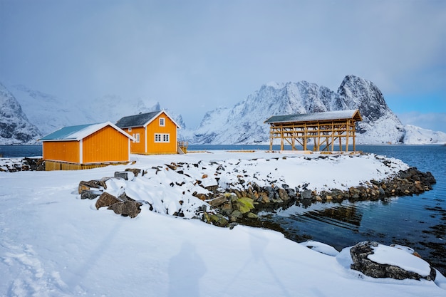 Rorbu-Haus und trocknende Flocken für Stockfisch-Kabeljau im Winter. Lofoten, Norwegen