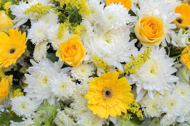 La rosa de flores de crisantemo amarillo y blanco estaba decorada con hojas verdes como corona