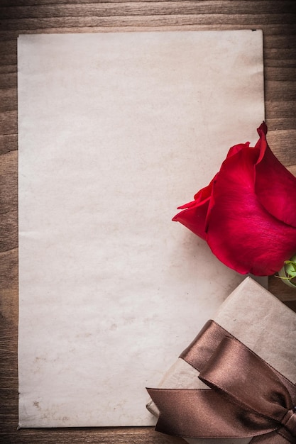 Rosa roja caja de regalo en blanco hoja de papel concepto de vacaciones