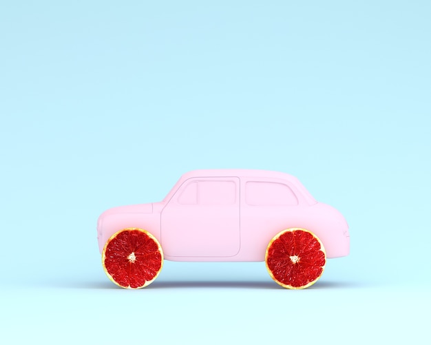 Foto rosa de la rueda y del coche del diseño del pomelo en fondo azul en colores pastel. comida mínima y estafa de fruta