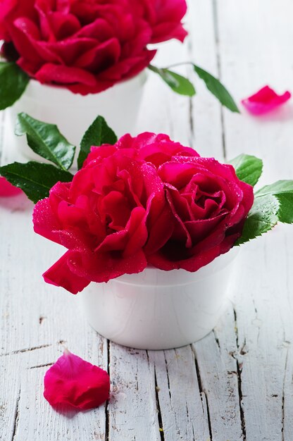 Rosas rojas en la mesa de madera