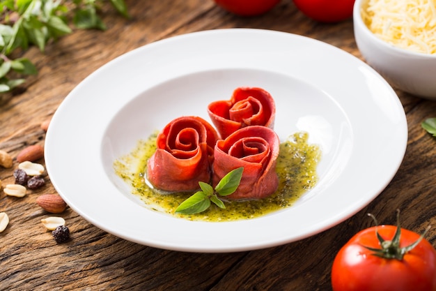 Foto rosenförmige nudeln mit pesto-sauce