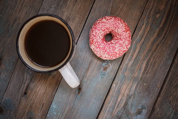 Rosquinha fresca com café na mesa de madeira