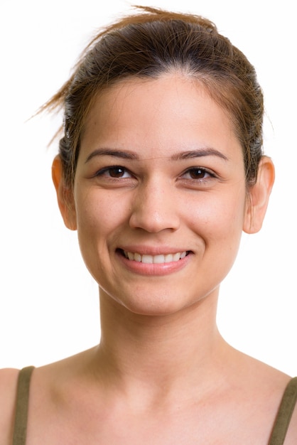 Foto rosto de uma bela jovem feliz sorrindo com o cabelo amarrado