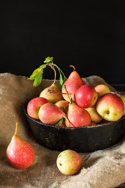 rote Birnen auf rustikalem Holztisch, Vegan, Diätnahrung. Herbsternte Saftige Früchte auf der Tasche. V