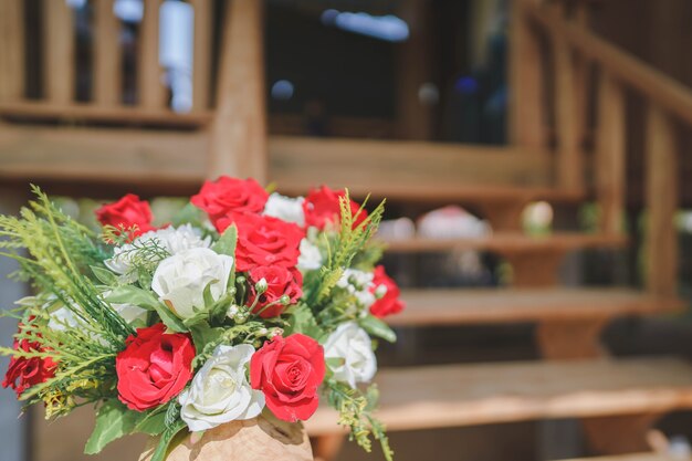 Rote Blumensträuße schmücken die Treppe des Hauses für eine Feier, Willkommen bei der Hochzeit.