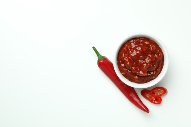 Rote Chilischote und Sauce auf Weiß