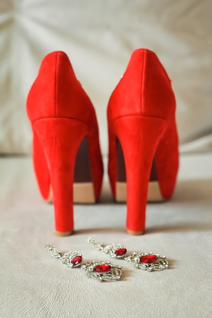 Rote Damenschuhe stehen auf der Fensterbank, Hochzeit, Boutonniere.