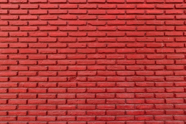 Rote Farbe mit einer alten Grunge-Wand-Betonstruktur als Hintergrund