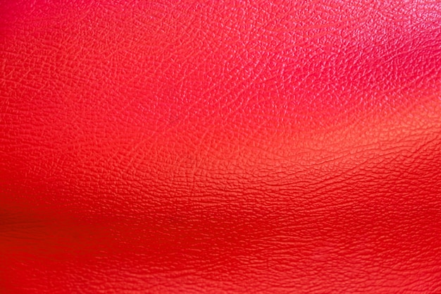 Rote Lederoberfläche für Hintergrund. Material für Schuhe und Handtaschen