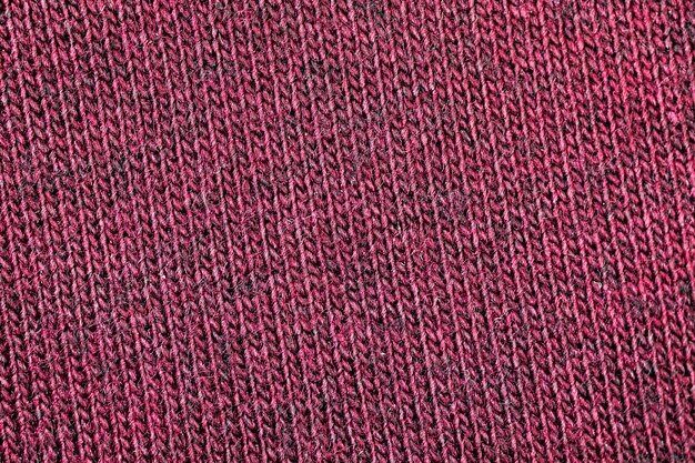 Rote Stoffstruktur aus natürlichem Baumwoll- oder Leinentextilmaterial, warmer roter Pullover, Nahaufnahme, hochauflösender Hintergrund