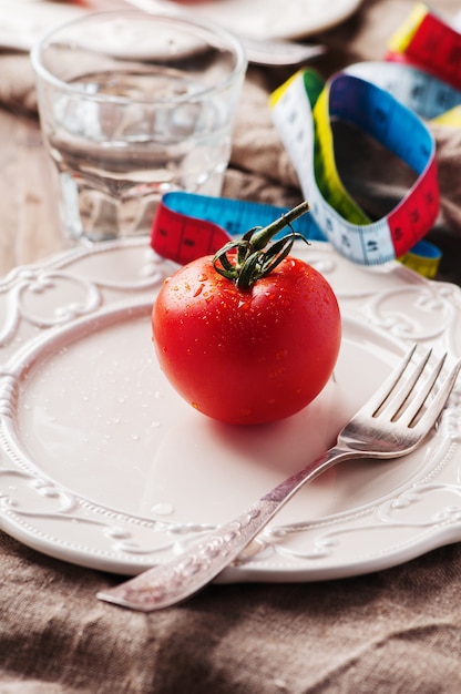 Rote Tomate, Maßband und Wasser