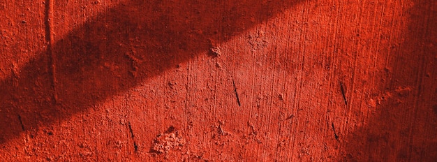 Rote wändegruseliger hintergrundbetonwand verputzter roter kratzerhintergrundgrunge textur