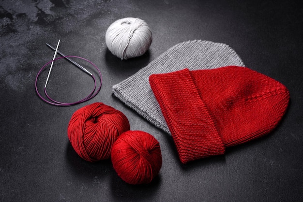 Rote warme gestrickte Damenmütze auf konkretem Hintergrund Hobbys und Freizeit