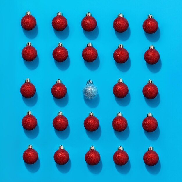 Rote Weihnachtskugel unter blauen Kugeln. Persönlichkeitskonzept