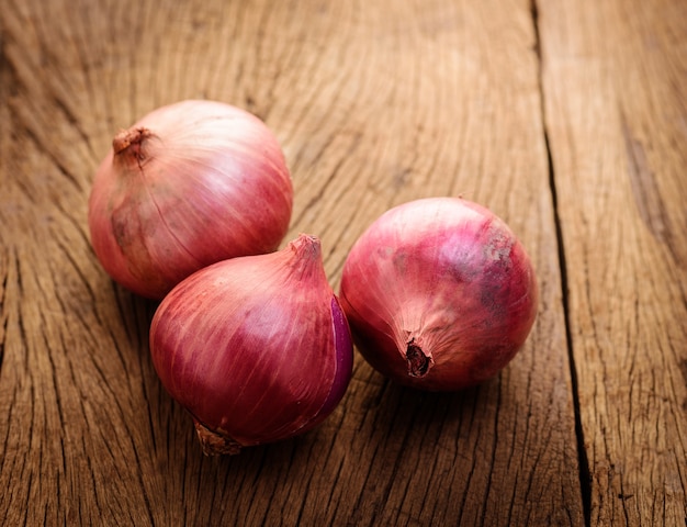 rote Zwiebeln auf einem hölzernen Hintergrund