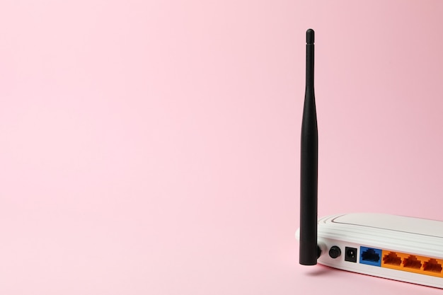 Roteador Wi-Fi com antenas externas em fundo rosa