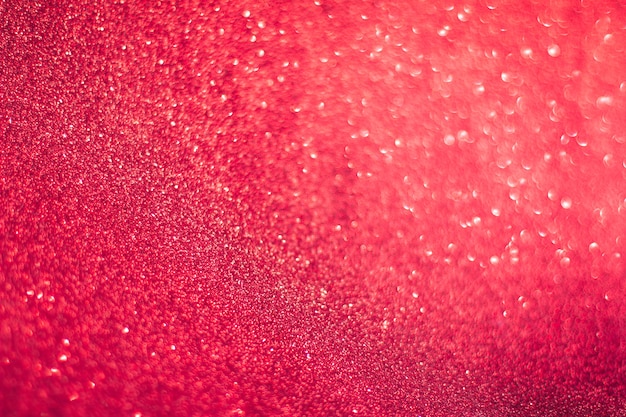 Roter abstrakter Hintergrund mit Bokeh und Glitzer, Valentinstag, Weihnachten und Neujahr, roter Glitzer mit weichem selektivem Fokus, Weihnachtsbeleuchtung