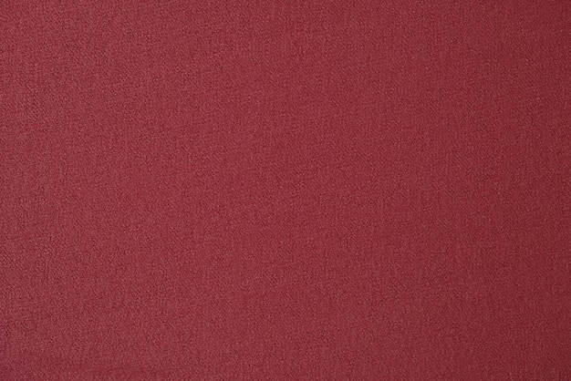 Roter einfarbiger Stoff als Hintergrund Rotes Textil hautnah