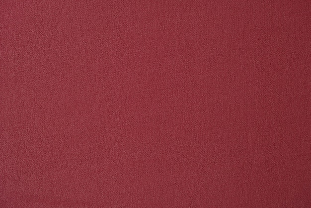 Roter einfarbiger Stoff als Hintergrund Rotes Textil hautnah