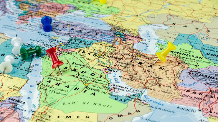 Roter und gelber Stift gesetzt an der Saudi-Arabien- und Iran-Karte.