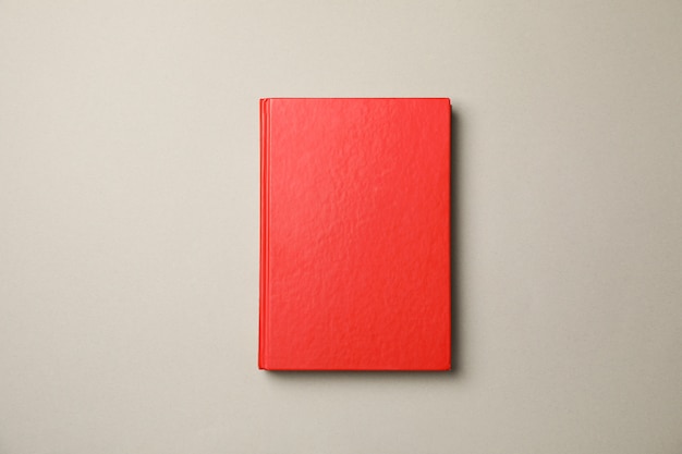 Rotes Buch auf grauem Hintergrund, Draufsicht und Kopierraum