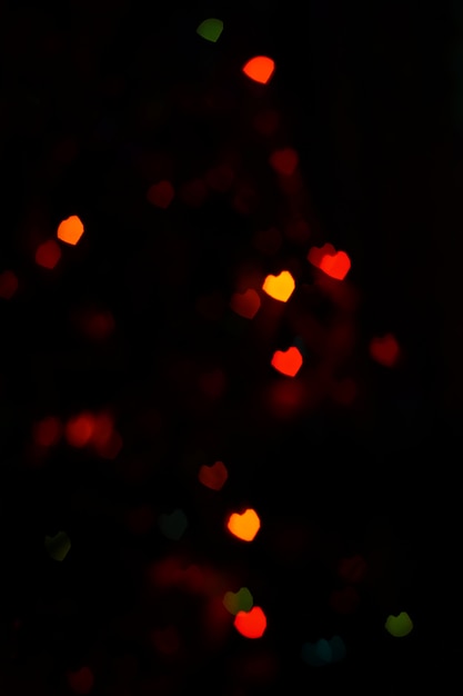 Rotes orangefarbenes herzförmiges Bokeh