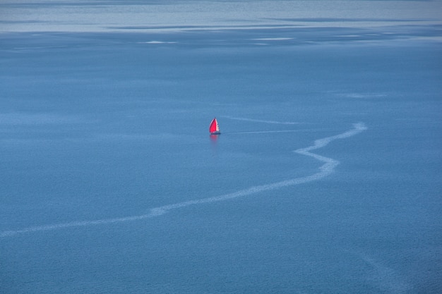 Rotes Segelboot auf dem Meer