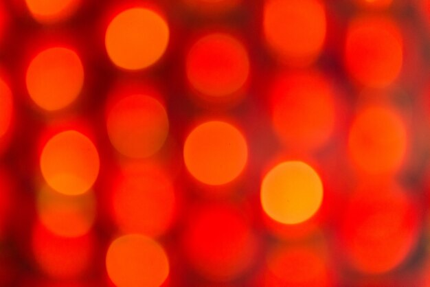 Rotes und orangefarbenes Feiertagsbokeh. Abstrakter Hintergrund