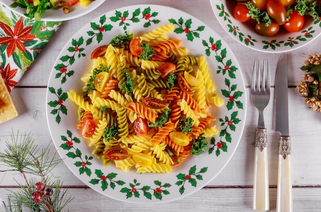 Rotini-Nudeln und Kirschtomate mit grünem Salat auf Weihnachtstisch