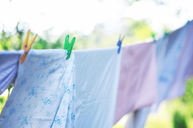 Roupas secas do lado de fora roupas em uma corda prendedores de roupa em um varal no verão