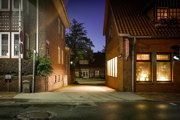 Rua em meio a edifícios iluminados à noite