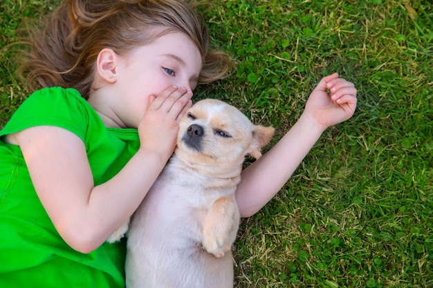 Rubia niña feliz con su retrato de perrito chihuahua