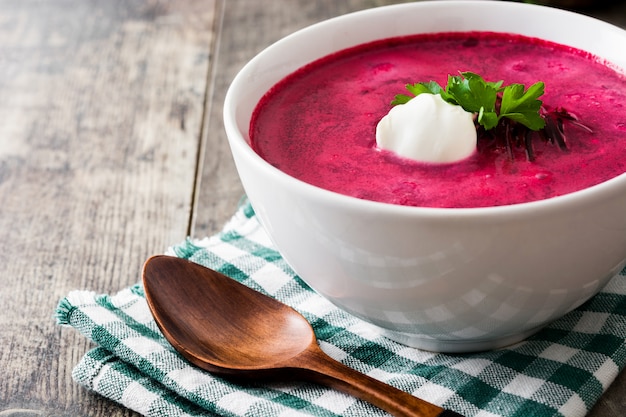 Rübensuppe in weißer Schüssel auf Holztisch