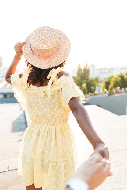 Rückansicht Foto einer afrikanischen jungen Frau, die im Freien geht