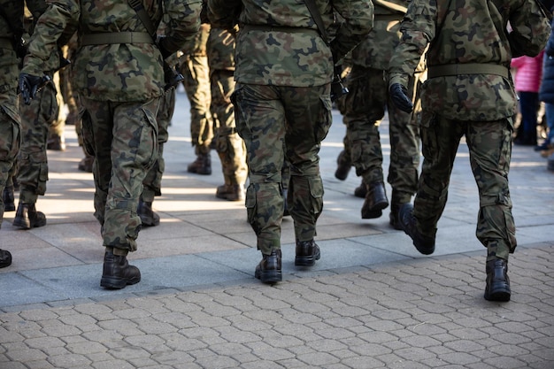 Rückansicht marschierender Soldaten in voller Uniform