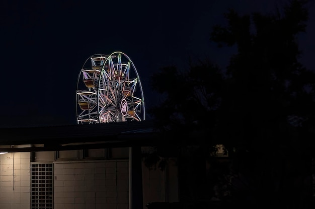 Foto rueda de la fortuna iluminada por la noche