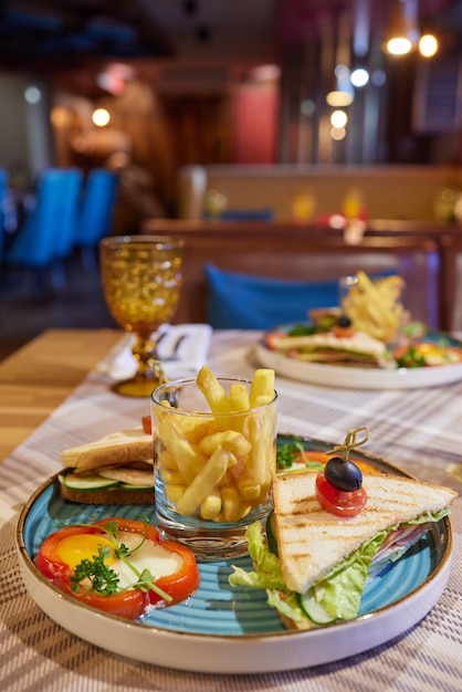 Rührei-Sandwich mit Frischkäse auf Roggen-Toast zum Frühstück auf weißem Hintergrund Gesundes Frühstück oder Snack