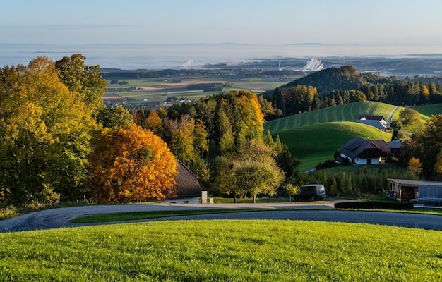 Ruhiger, sonniger Herbstmorgen mit ländlicher Aussicht vom Gmundnerberg mit nebliger Landschaft im fernen Österreich