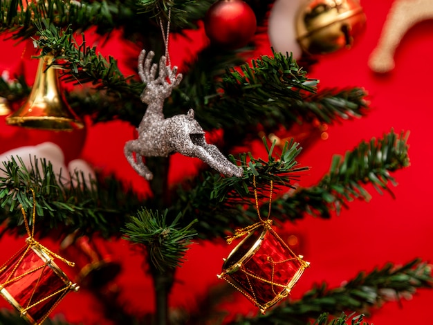 Árvore de Natal decorada com fundo vermelho.