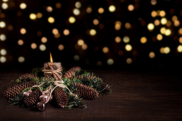 Árvore de Natal e cones decorados com velas em chamas.