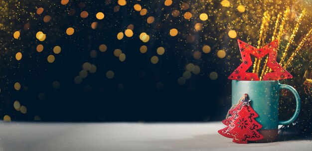 Árvore de Natal e estrela na caneca com bokeh de fundo claro festival