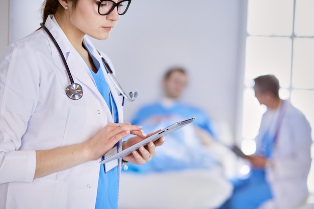 Ärztin mit Tablet-Computer in der Krankenhauslobby