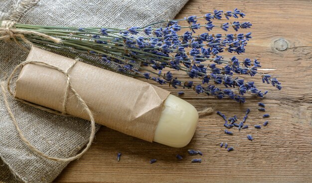 Saboneteira de lavanda com um buquê de lavanda em um fundo de madeira com