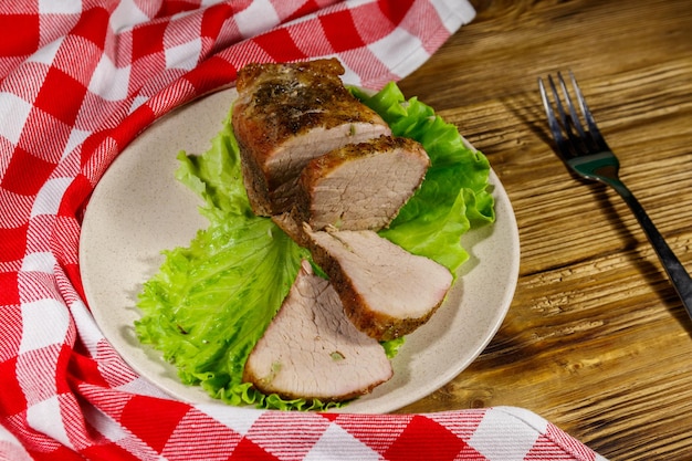 Saborosa carne de porco assada com especiarias em uma mesa de madeira