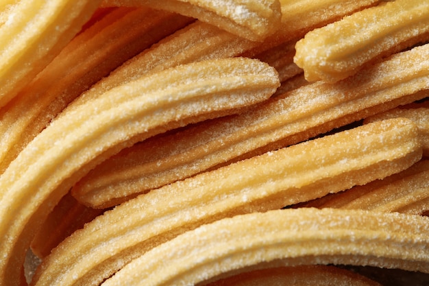 Saborosos churros doces em todo o fundo