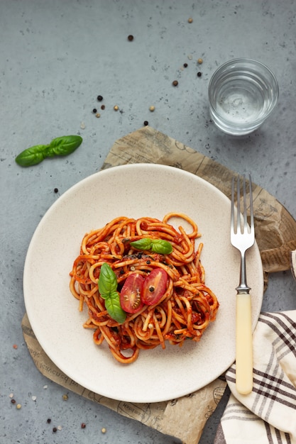 Sabrosa pasta con salsa de tomate picante, tomates cherry y albahaca.