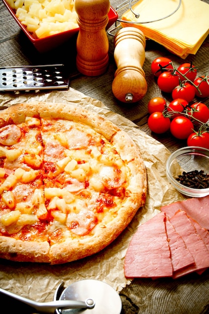 Sabrosa pizza e ingredientes en madera