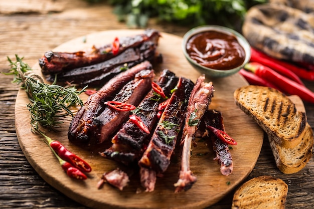 Sabrosas costillas de cerdo a la parrilla con chiles y hierbas de perejil.